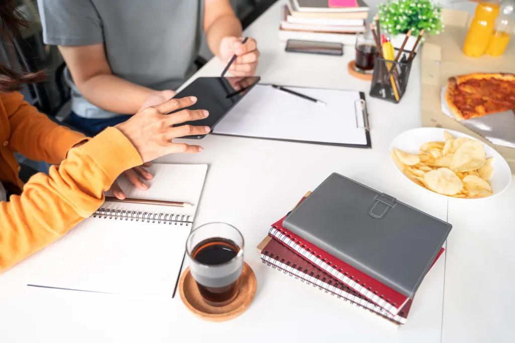 Branded custom notebooks displayed at a conference, showcasing the company's logo and design.