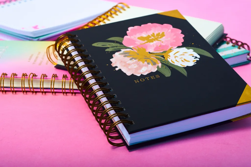 Notebooks With A Beautiful Design On A Pink Desk