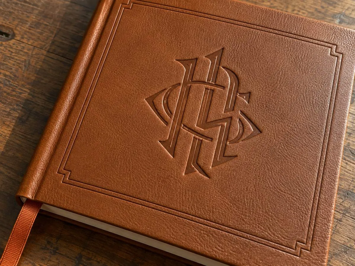 blind embossed monogram on PU leather notebook cover