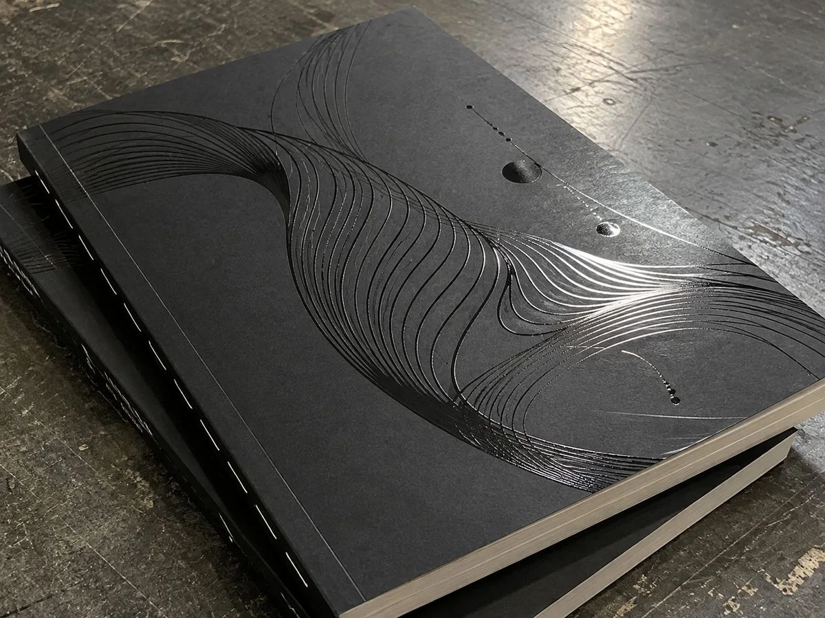 spot UV gloss logo catching light on matte cover